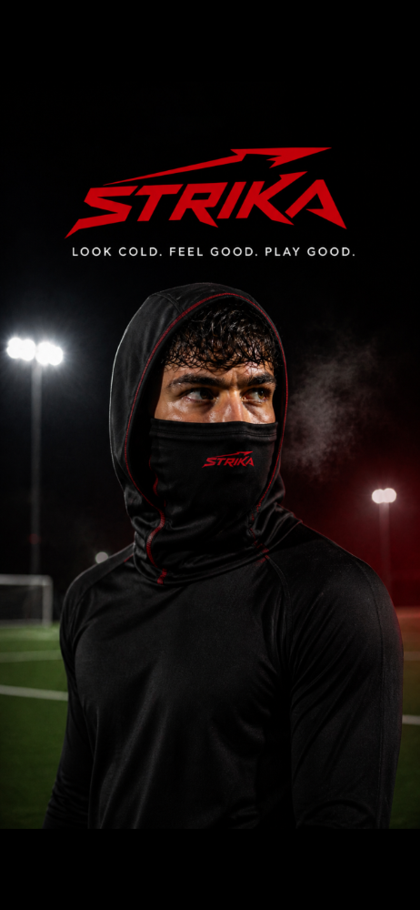 Footballer wearing STRIKA snood under stadium lights